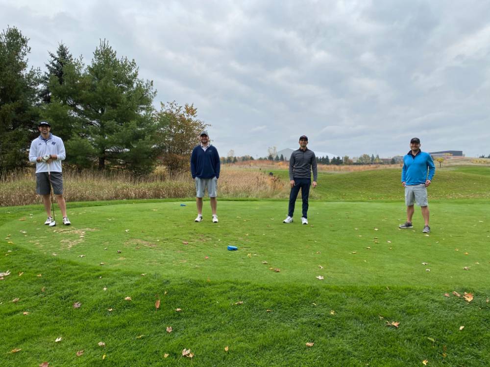 Four alumni on golf course
